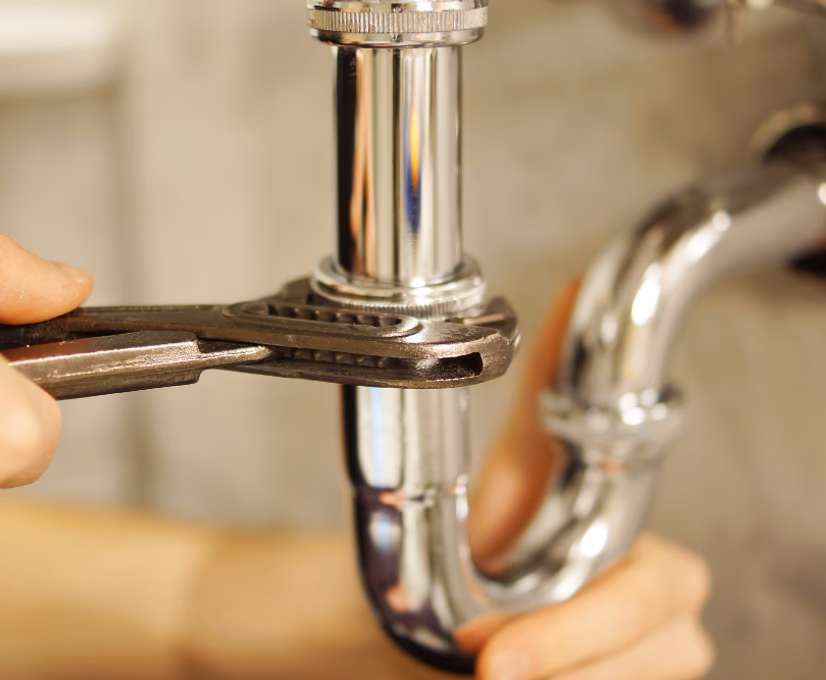 plumbing pipes under a sink
